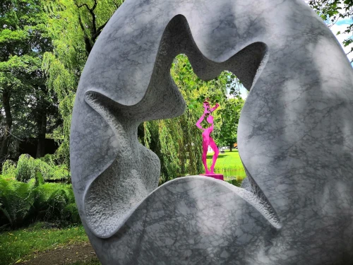 A pink woman viewed through a work of art.